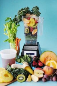 Blender with fruits and veggies