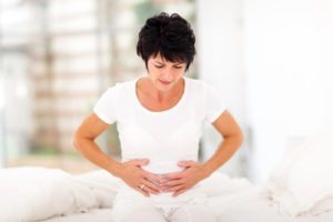 woman suffering with pain from digestive issues