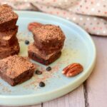 Photo of black bean brownies with nuts on place from "Dark Chocolate Black Bean Brownies" recipe by Green Smoothie Girl