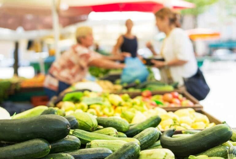 Photo of organic produce at open space market from "Is Buying Organic Food Always Necessary?" by Green Smoothie Girl