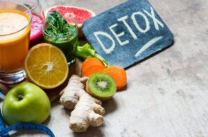 Photo of fruits and vegetables with smoothies next to sign saying DETOX from "{VIDEO} How to Change Your Weight “Set Point” Forever" by Green Smoothie Girl