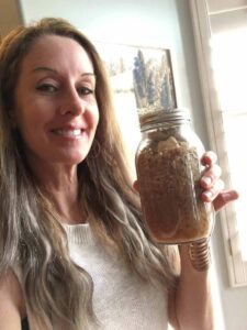Robyn Openshaw and a jar of fermented sauerkraut.