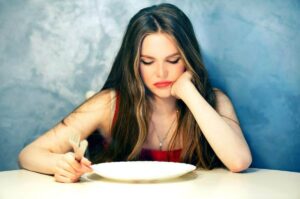 Photo of bored woman staring at empty plate from "{VIDEO} How to Change Your Weight “Set Point” Forever" by Green Smoothie Girl