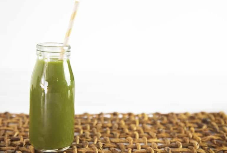 Photo of green smoothie in glass with straw from "Does Everything that Goes in Your Mouth Have to Taste Good?" by Green Smoothie Girl