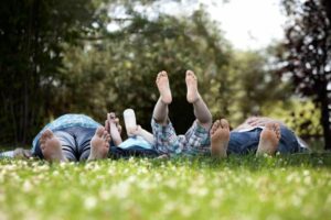 A family laying on the grass together from "{VIDEO} How to "Ground" and "Charge" for High Energy Every Day!" by Green Smoothie Girl