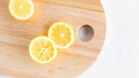 Photo of cut lemons on wood cutting board from "Mums’ Magical Antiviral Hot LemonAid Tonic" by Green Smoothie Girl