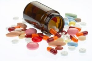 Image of pills near a prescription pill bottle, from "Which Natural Treatments for ADHD Symptoms Are Backed by Science?" at Green Smoothie Girl.