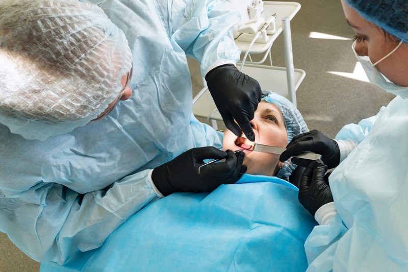 Dentists performing a tooth extraction