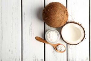 Coconut oil is legendary for its numerous health benefits. Photograph of whole coconuts and solid coconut oil.