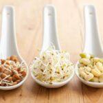 Photo of three white spoons holding sprouted beans from "How Digestive Enzymes Work--And Why You’re Probably Deficient" blog post by Green Smoothie Girl