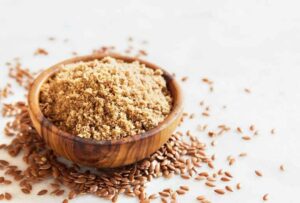 Photo of ground flax in wooden bowl from "15 Ways To Use Sprouted Flaxseed" by Green Smoothie Girl