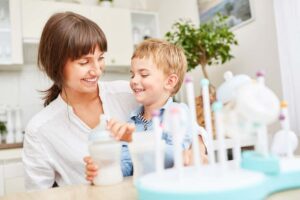 Image of a mother and child sitting together and smiling, from "Which Natural Treatments for ADHD Symptoms Are Backed by Science?" at Green Smoothie Girl. 