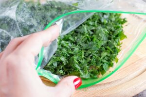 Frozen greens in a zipped plastic bag, from "How To Freeze Spinach and Other Leafy Greens For Later (With Shortcuts!)" at Green Smoothie Girl.