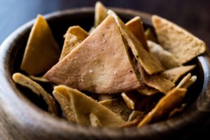 Pita Bread Chips or Snacks in a wooden bowl, from "Three Healthy Alternatives to Chips" at Green Smoothie Girl.