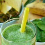 Photo of Green spinach and pineapple smoothie on table from "Turning Green Smoothie" recipe by Green Smoothie Girl