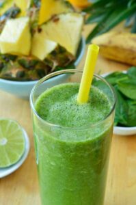 Photo of Green spinach and pineapple smoothie on table from "Turning Green Smoothie" recipe by Green Smoothie Girl