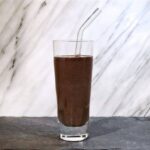Photo of dark purple smoothie against marble background from "ultimate green smoothie"recipe by Green Smoothie Girl