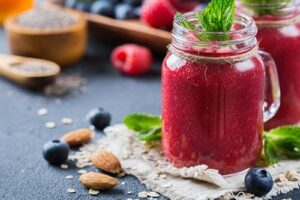 Photograph of a bright pink smoothie in a glass jar, from "10 Easy Green Smoothies Kids Will Love" at Green Smoothie Girl