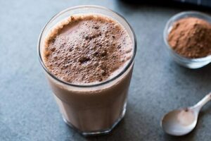 Photograph of a chocolate smoothie in a tall glass, from "10 Easy Green Smoothies Kids Will Love" at Green Smoothie Girl