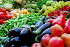 Photograph of fruits and vegetables at an outdoor market, from "Green Smoothies for High Blood Pressure Control" at Green Smoothie Girl.