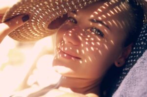 Photograph of a woman's face with sunlight streaming through a straw hat, from "The Health Benefits of Kelp and Dulse (and How to Use It)" at Green Smoothie Girl.