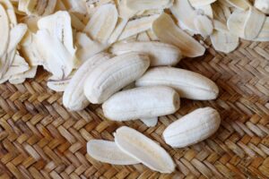 Photograph of banana chunks and slices on a textured mat, from "How to Make Creamy Smoothies Without Yogurt or Dairy (With Recipes!)" at Green Smoothie Girl.