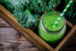 Healthy green smoothie with kale in mason jar, from “These Anti Inflammatory Smoothie Recipes Target Joint Pain And More” at Green Smoothie Girl.