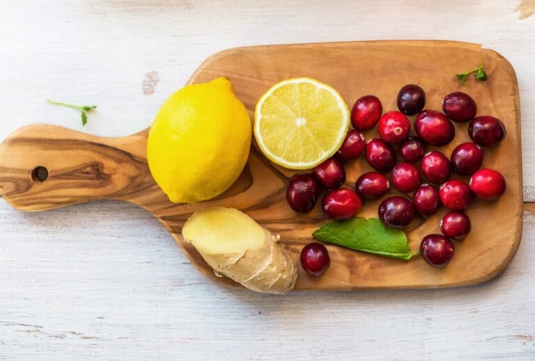 Photo of cranberries lemons and ginger on cutting board from "Natural Treatments for Urinary Tract Infections (UTIs)" by Green Smoothie Girl