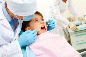 Photo of young boy in dental chair receiving a dental exam from ""dental work and the headache causes you never saw coming" by Green Smoothie Girl