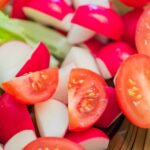 close up of fresh vegetrian salad from tomatoes, radish and lettuce