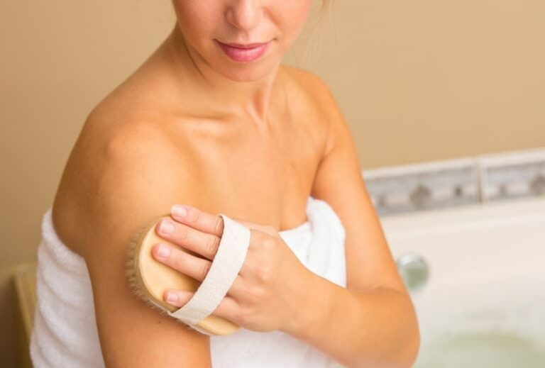 Photo of person dry brushing, from "Skin Brushing With A Dry Brush: Why And How, Step By Step" at Green Smoothie Girl