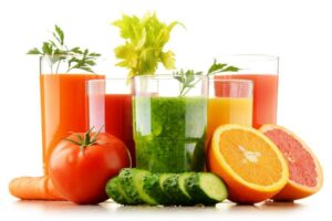 Photo of fruits and vegetables with their juices in glasses, from "Why Ketosis Diets Will Fail: The Paleo and Keto Manifesto" at Green Smoothie Girl