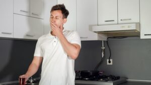 Photo of tired man in kitchen from "no energy? fatigue causes you haven't considered" blog post by Green Smoothie Girl