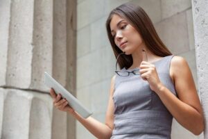 Photo of Asian woman lawyer reading papers from "What To Do About Toxic Paint, Carpet, Furniture (Offgassing For Years!)" by Green Smoothie Girl