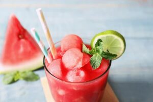 Photo of watermelon lime green smoothie drink with straw from "Green Smoothies For Crohn’s Disease: Research And Recipes" by Green Smoothie Girl