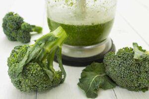 Photo of broccoli smoothie and broccoli heads from "Broccoli Blitz Smoothie" recipe by Green Smoothie Girl