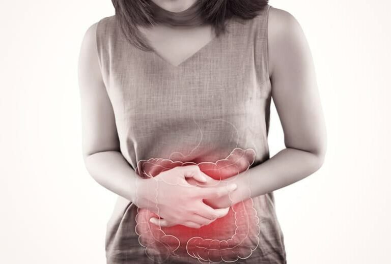 Image of woman clutching red pulsating stomach from "Green Smoothies For Crohn’s Disease: Research And Recipes" by Green Smoothie Girl