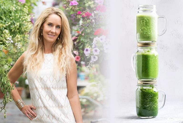 Photo of Robyn Openshaw smiling with hand on hip and stack of green smoothies from How To Make A Green Smoothie: The Foolproof Guide" by Green Smoothie Girl