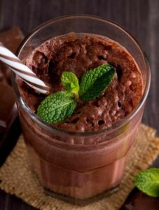 Photo of overhead chocolate smoothie with mint leaves from "Chocolate Cherry Shake" recipe by Green Smoothie Girl