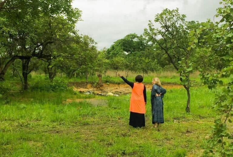 Photo of African woman pointing and white woman looking from "Why I Love Mothers Without Borders, And How We Can Help Them Together" by Green Smoothie Girl