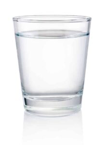 Photo of glass of clear water on white background from "Why I Developed The Flash Fast: Modified Fasting Made Easy And Fun" by Green Smoothie Girl