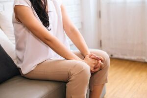 Photo of Mature Asian woman putting two hands together and praying at home from "Why I Developed The Flash Fast: Modified Fasting Made Easy And Fun" by Green Smoothie Girl