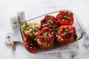 Photo of baked stuffed peppers in a glass baking pan from "Is Cooking With Aluminum Foil Safe? Why Researchers Say No"by Green Smoothie Girl