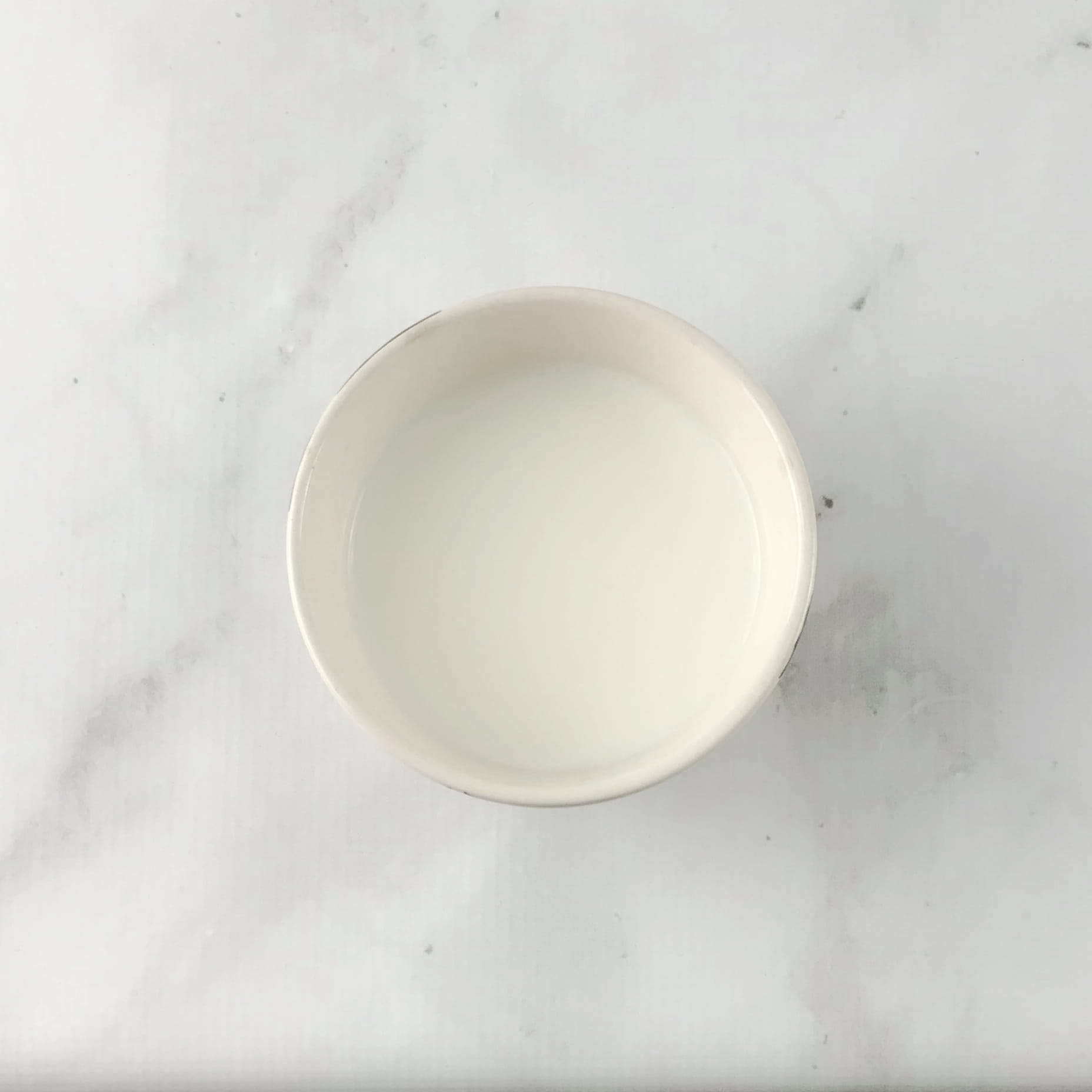 Photo of bowl of milk on marble counter from "How to Test your Probiotic Supplement at Home"by Green Smoothie Girl