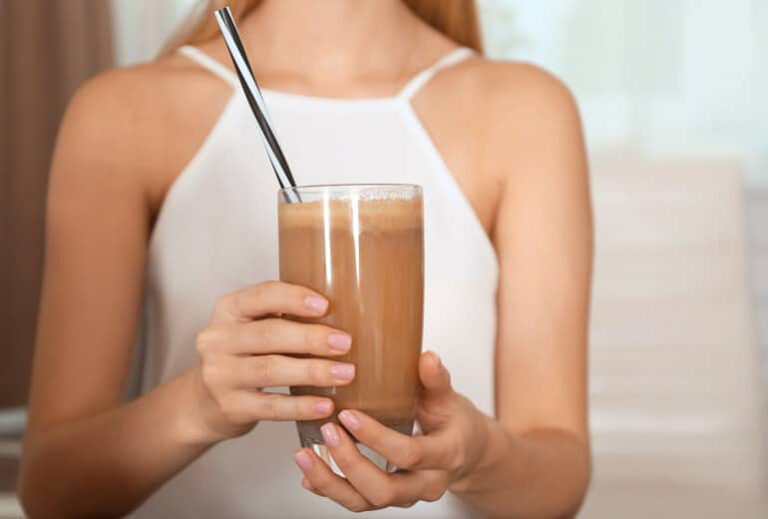 Photo of woman holding up a chocolate protein shake from "How Often Can You Do A 3-Day Modified Fast?" by Green Smoothie Girl