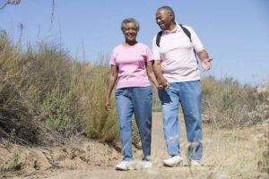 Photo of happy healthy African American senior couple on walking trail from "3-Day Water Fasting vs. 3-Day Modified Fasting" by Green Smoothie Girl