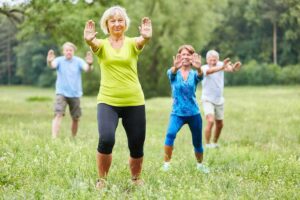 Photo of Seniors doing Qi Gong or Tai Chi exercise in nature from "14 Ways I Optimize My Health And Energy Every Day" by Green Smoothie Girl