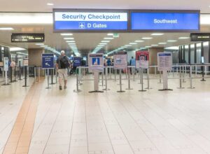Photo of man walking to TSA scanners in airport from "Is EMF Making You Sick?" blog post by Green Smoothie Girl