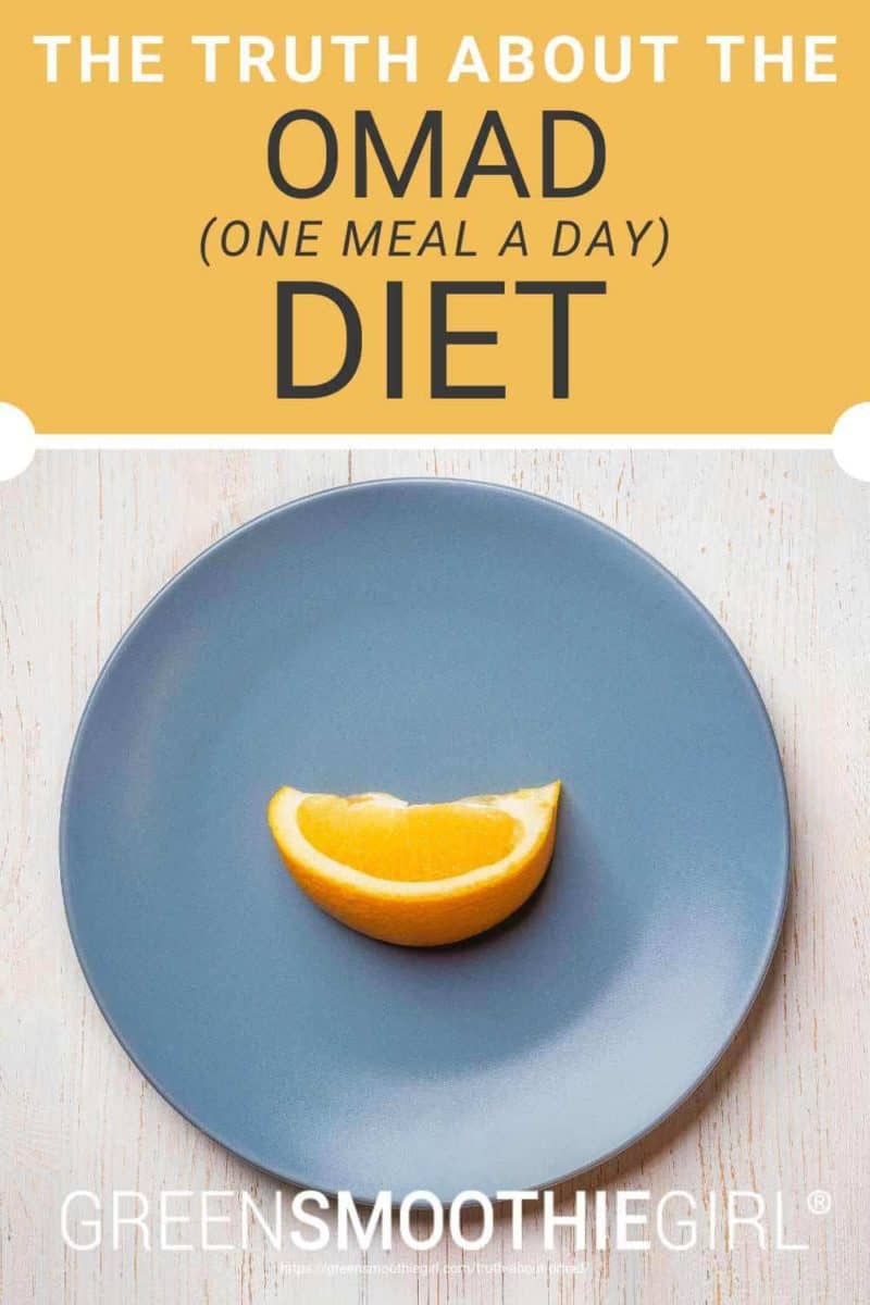 Photo of a top-view blue plate with a single slice of orange fruit on it and post's title text overlaid from "The Truth About The OMAD (One Meal a Day) Diet" by Green Smoothie Girl