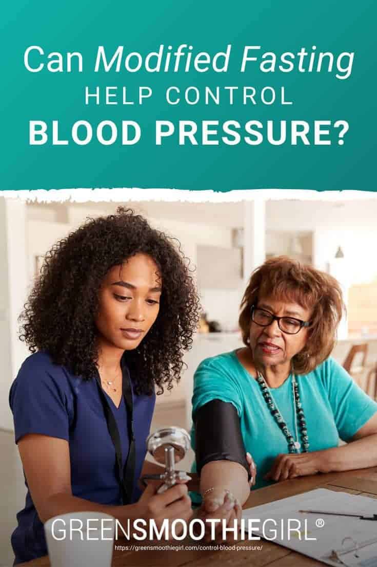 Photo of African American female nurse helping elderly woman take blood pressure and post's title text overlaid from "Can Modified Fasting Help Control Blood Pressure?" by Green Smoothie Girl